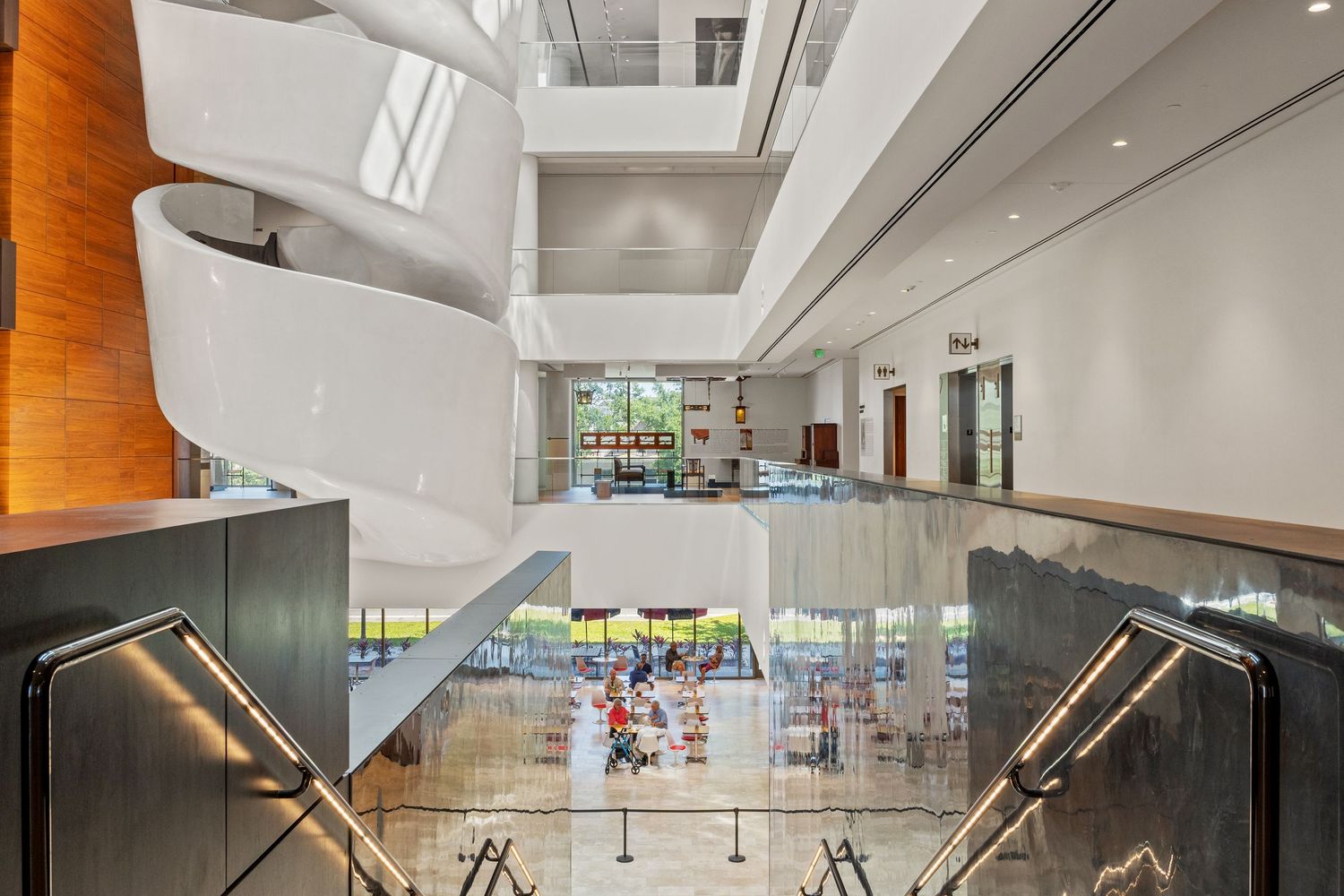 Modern museum interior with sleek lighting design and white walls creating an open exhibition space.