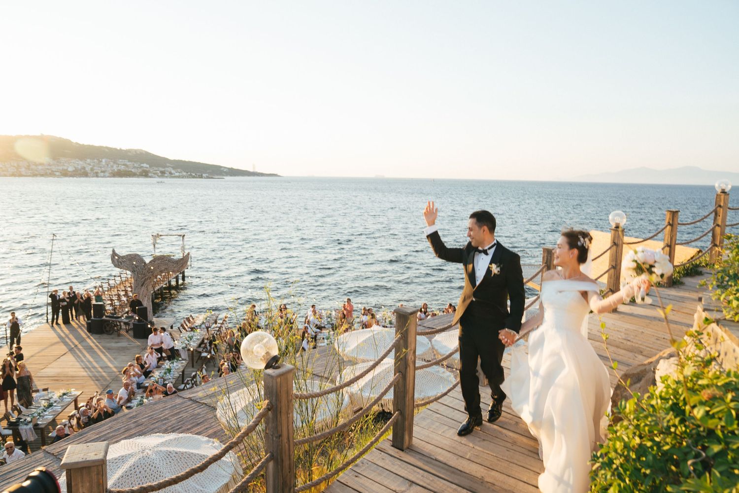 Two people getting ready for a special occasion in a sunlit room with one adjusting the other's hair.