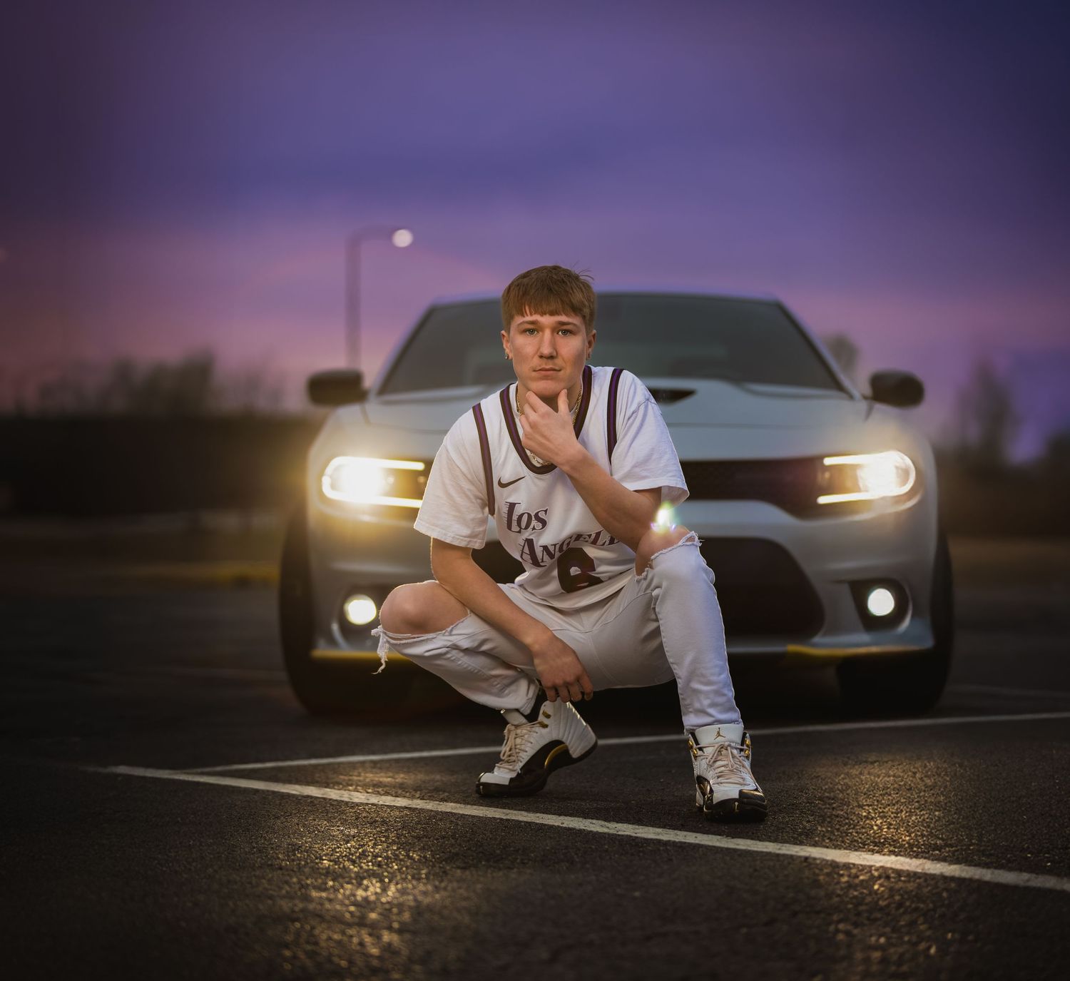 Dramatic sunset senior portrait with a dodge charger in Lincoln, Alabama, highlighting personalized hobby photography.