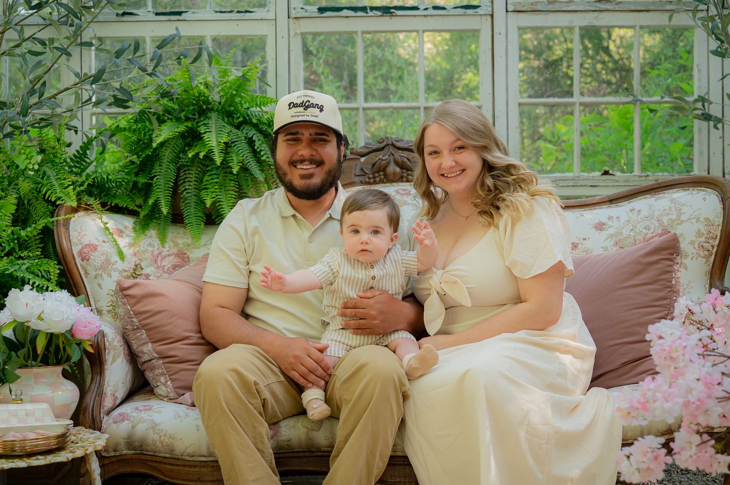 Indoor family photo session with floral decor and natural window lighting.