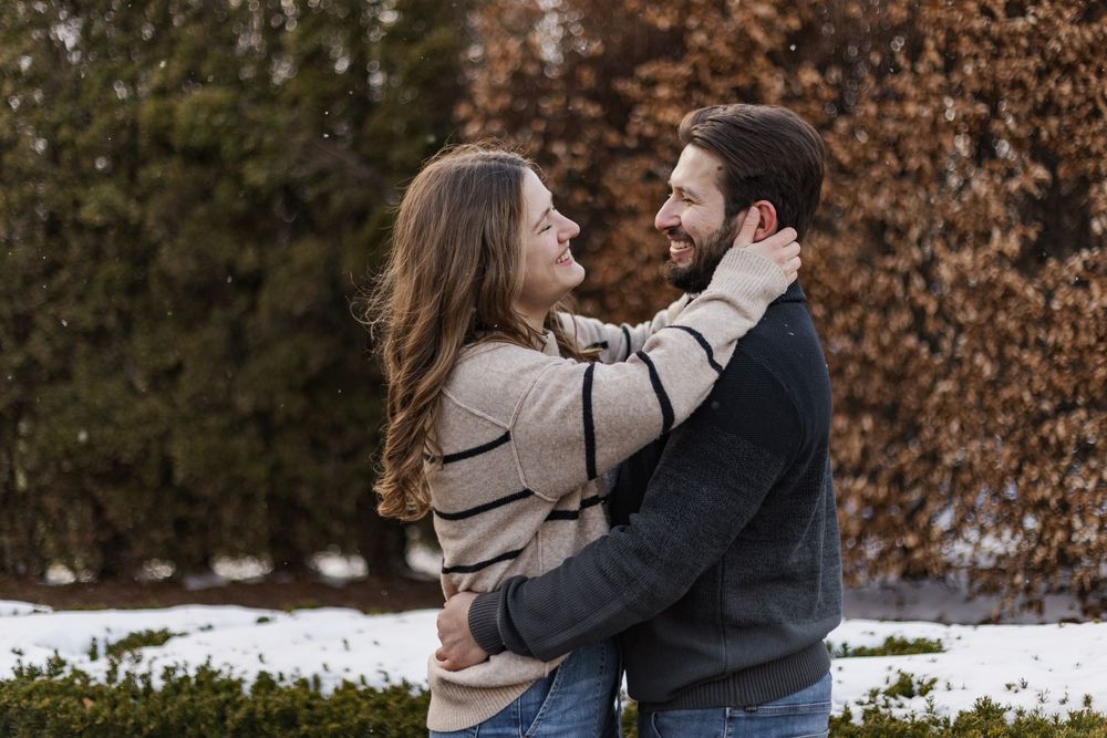 Couple embracing each other during engagement session at the guelph arboretum in guelph, ontario.