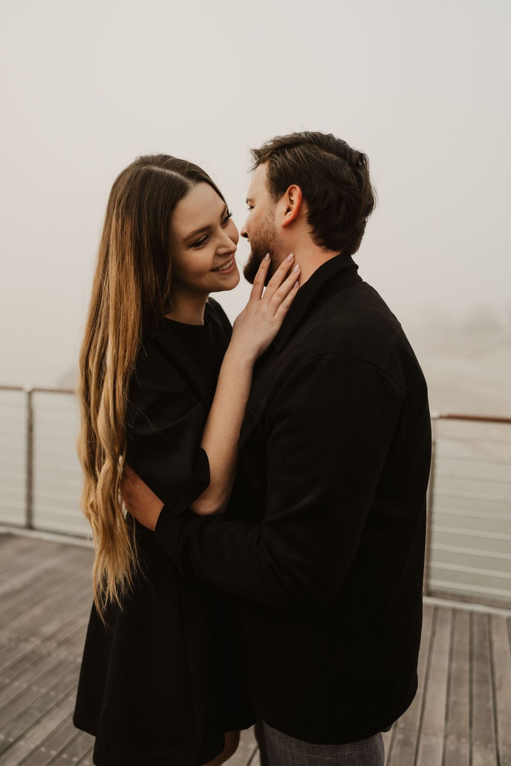 Wind-blown hair and candid smiles during a moody couple photoshoot in Portopiccolo.