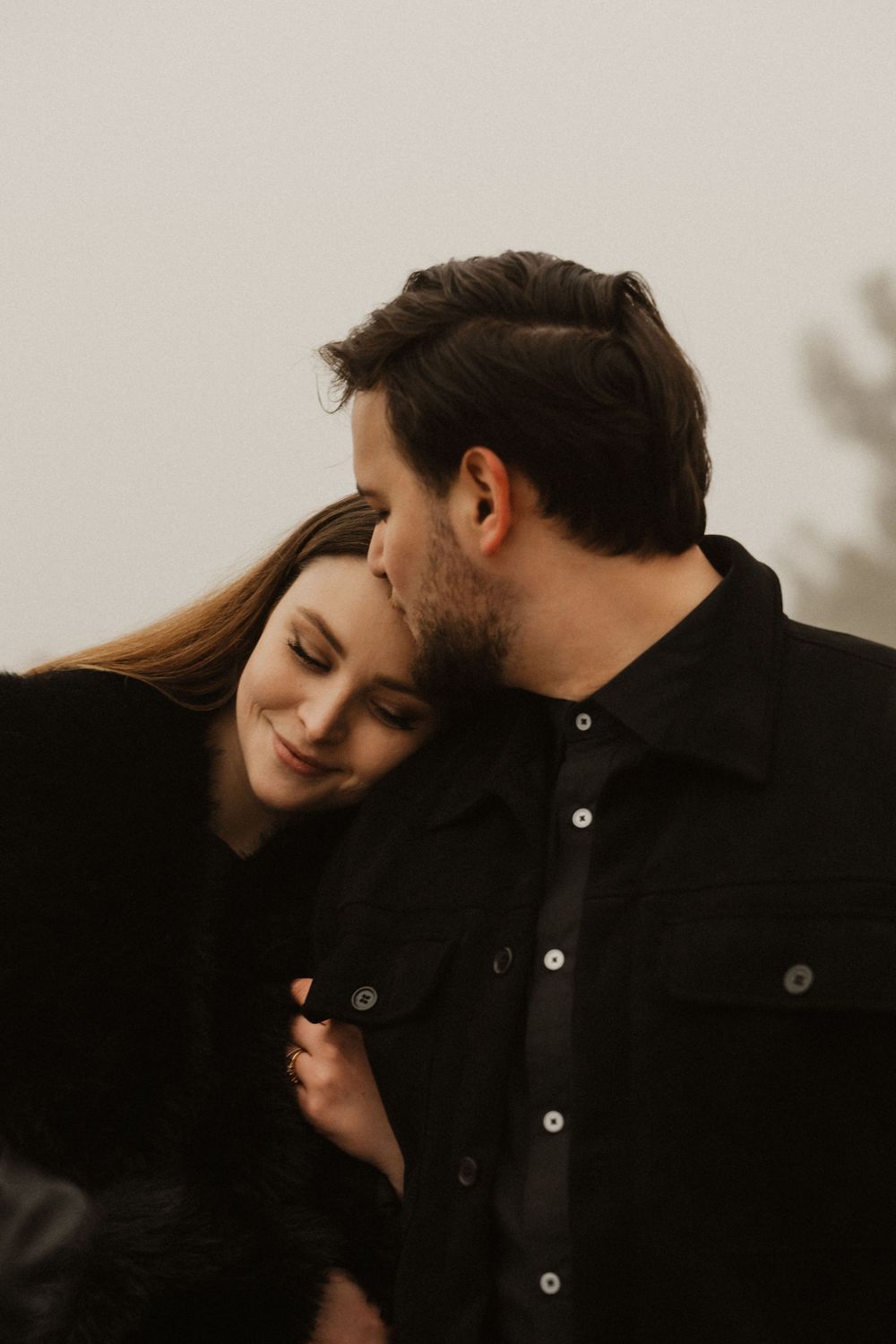 Romantic kiss on the docks of Portopiccolo marina during an atmospheric winter morning.
