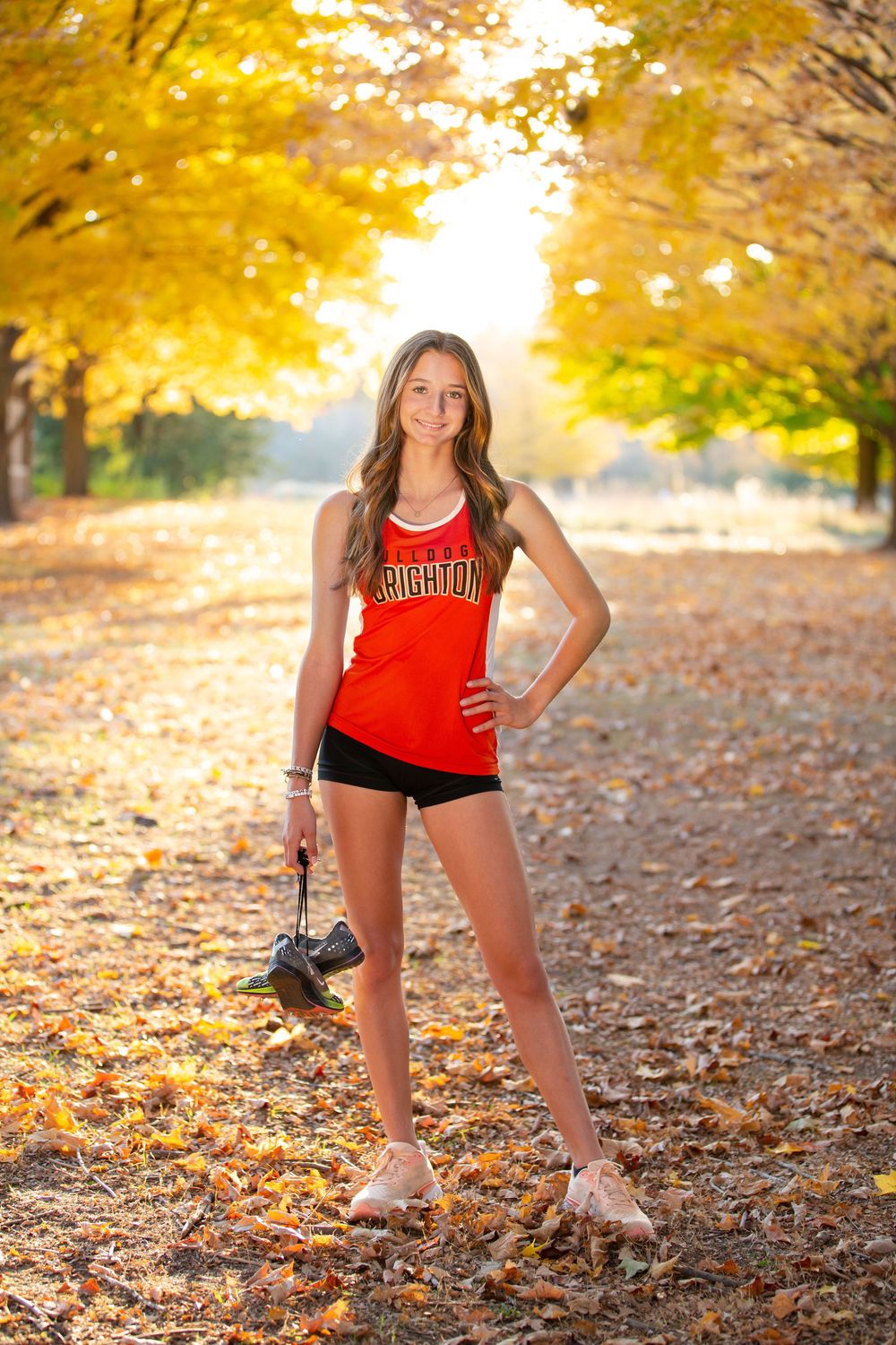 outdoor senior photos Brighton Michigan Hudson Mills Metropark senior girl portrait natural light with cross country gear