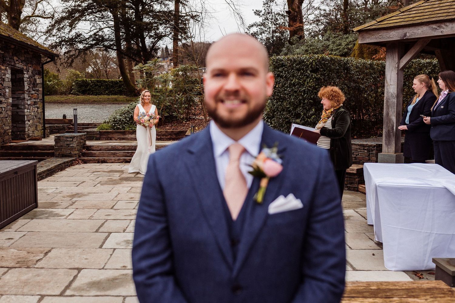 Bride in focus with groom in the foreground at Storrs Hall