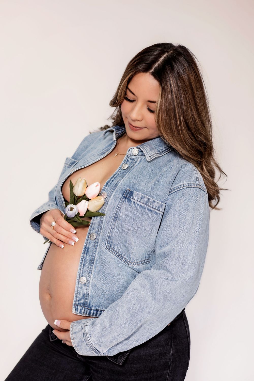 Photographer capturing the beauty of a glowing momma to be in a studio session in Fresno,ca