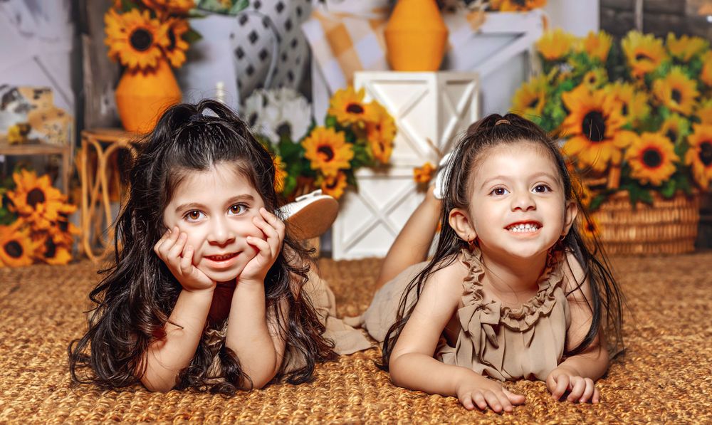 Photographer captures a stunning portrait of a siblings in a themed sunflower indoor session in Fresno, CA.