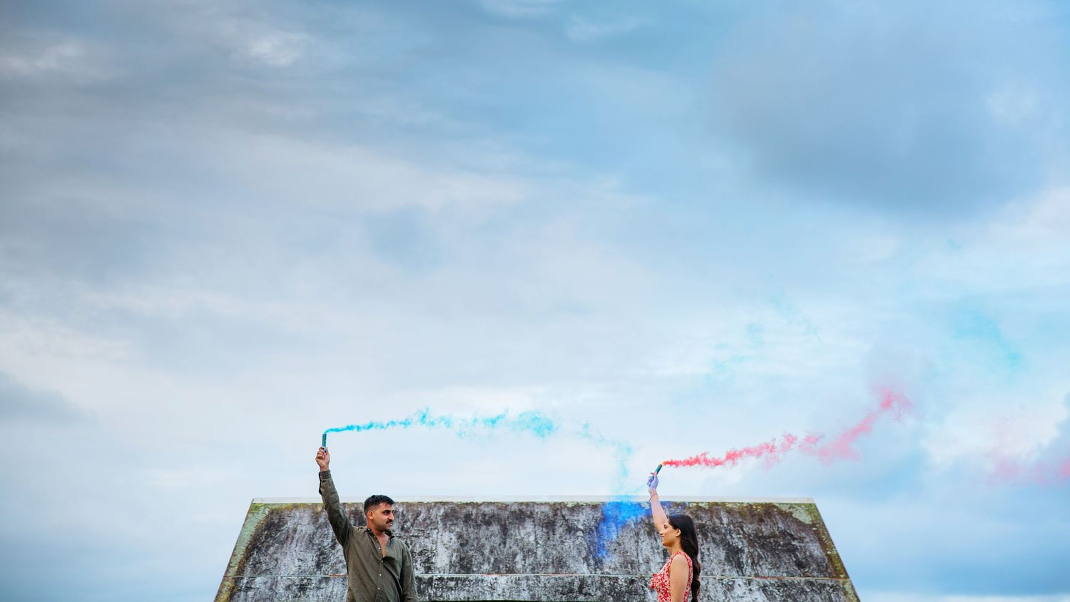 Couple at an Auckland nature reserve with smoke bombs during their engagement photo shoot