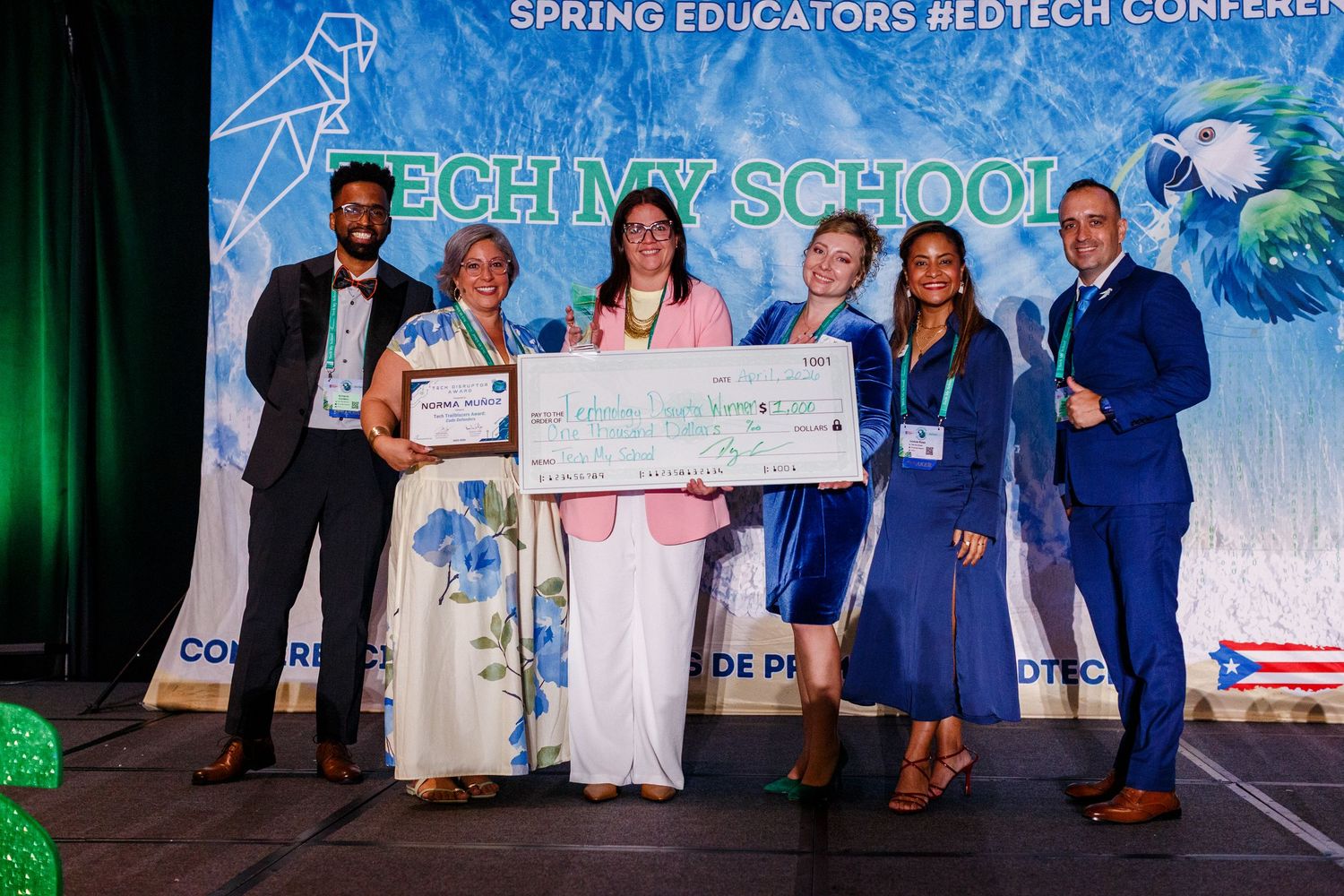 Staff on stage with an award winner at the Spring Educators Conference held at the Wyndham Grand Rio Mar in Rio Grande, Puerto Rico.