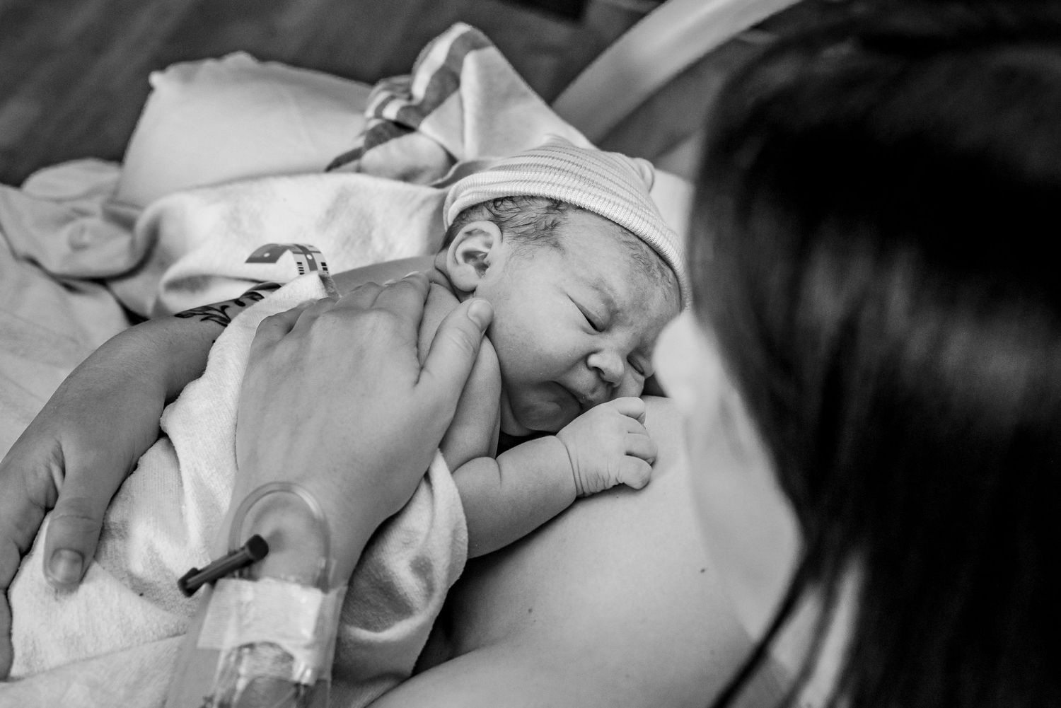 A series of black and white photos showing a newborn baby sleeping peacefully in different positions.
