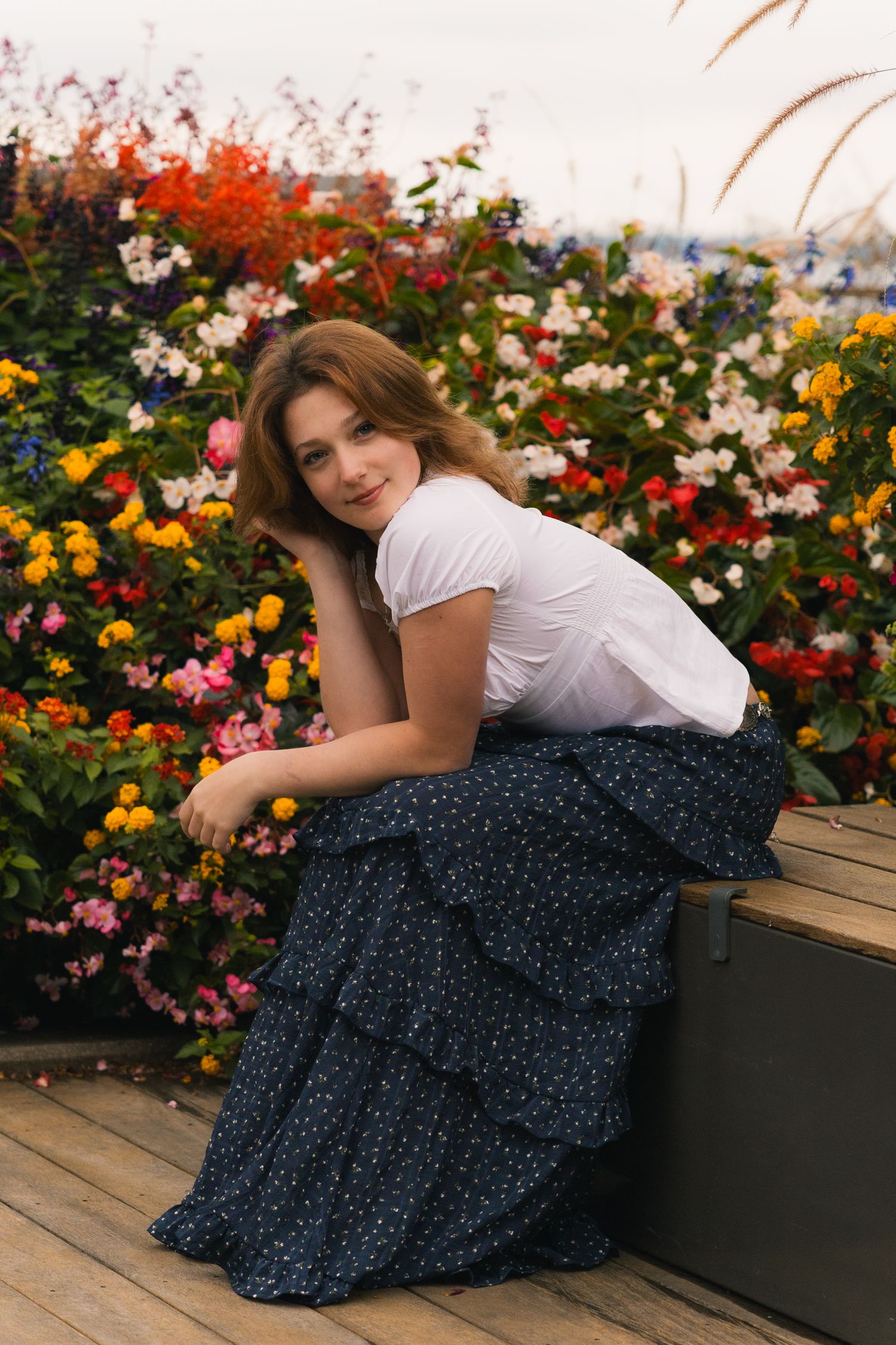 what to wear senior pictures madison wi professional photographer advice outdoor dressy outfit white ruffle top blue skirt colorful flowers