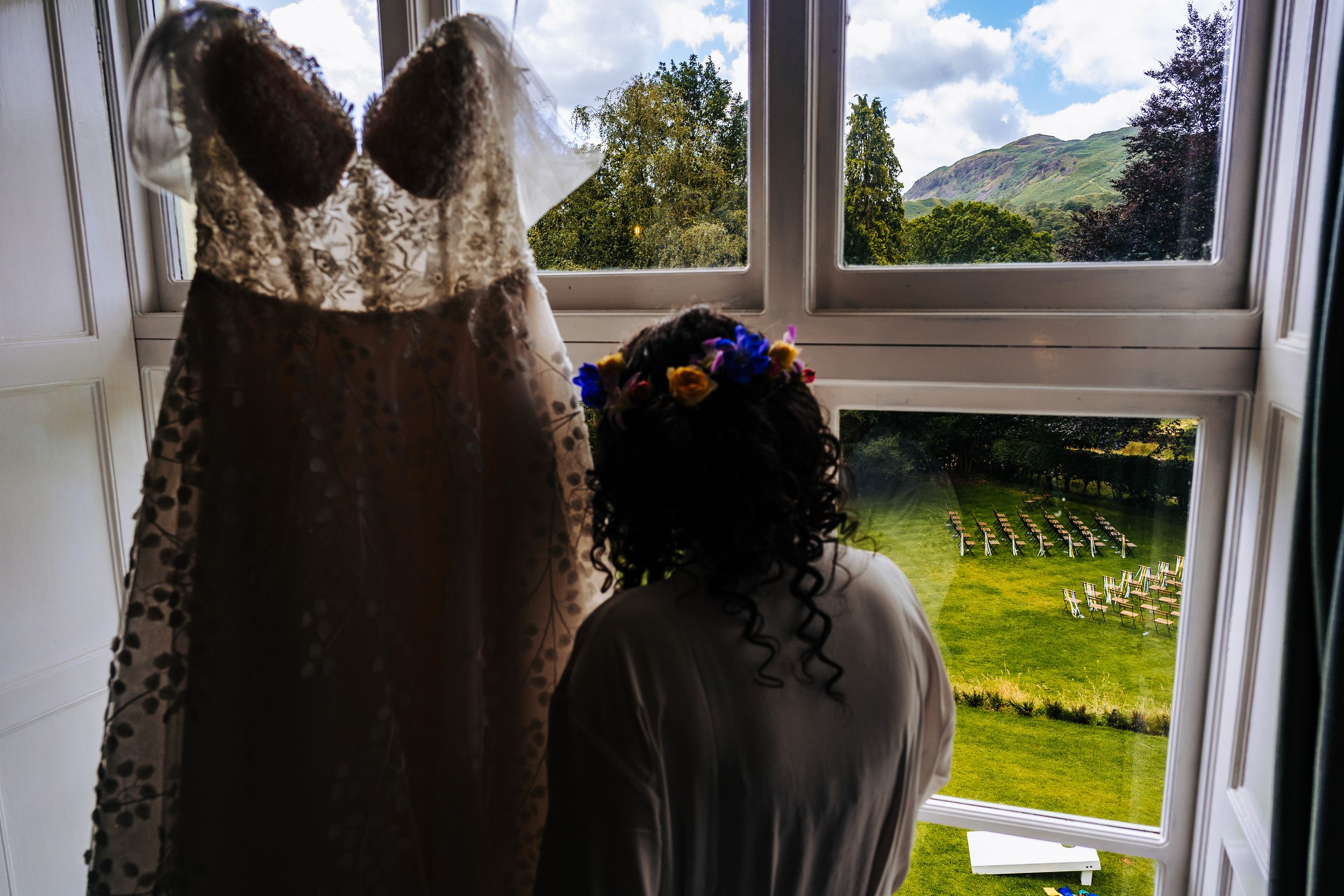 Bride to be looking out at her ceremony space at the lancrigg getting ready for an outdoor wedding overlooking the grasmere fells
