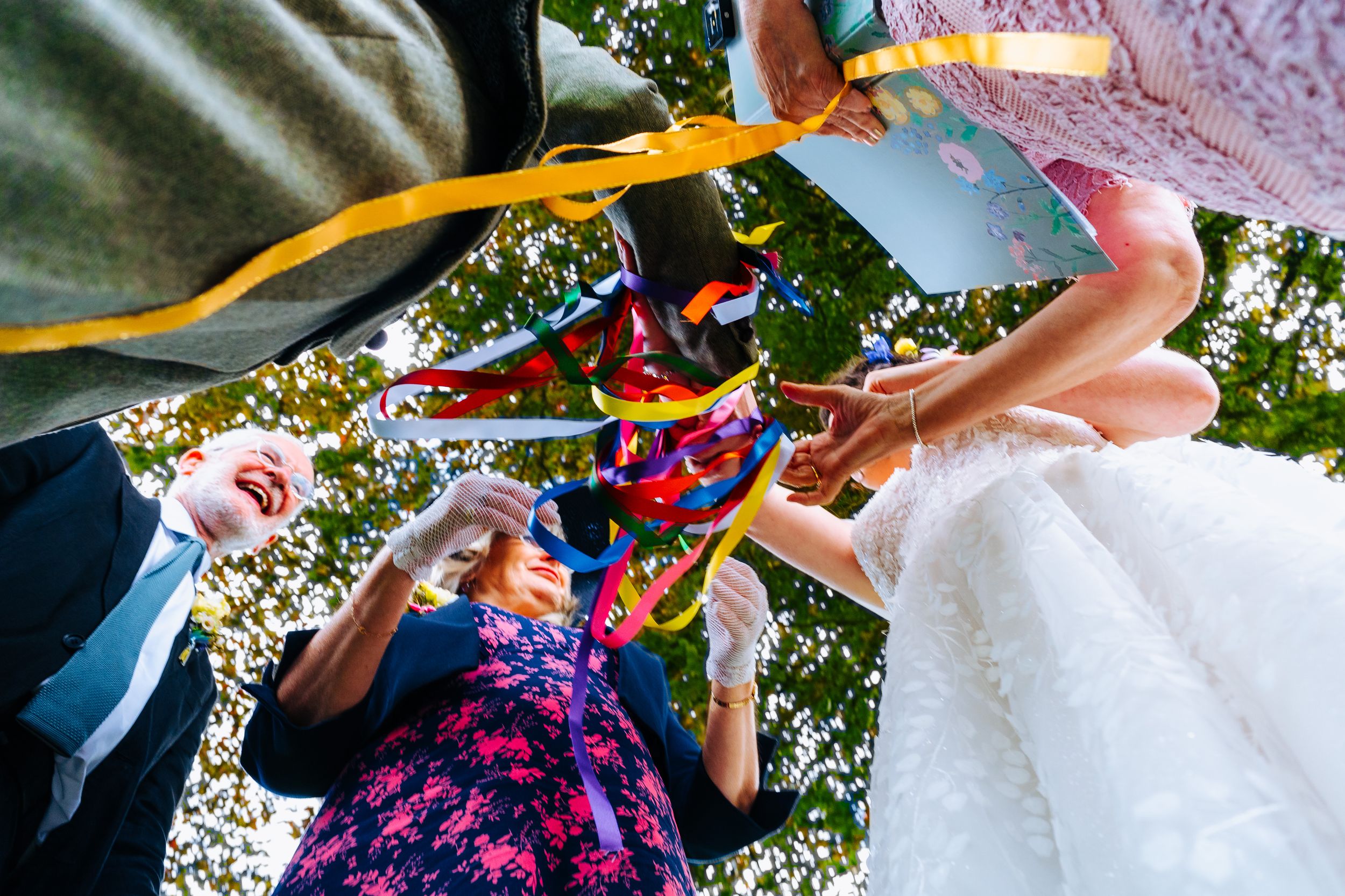 Traditional Handfasting ceremony with colour ribbons shot from an unusual viewpoint