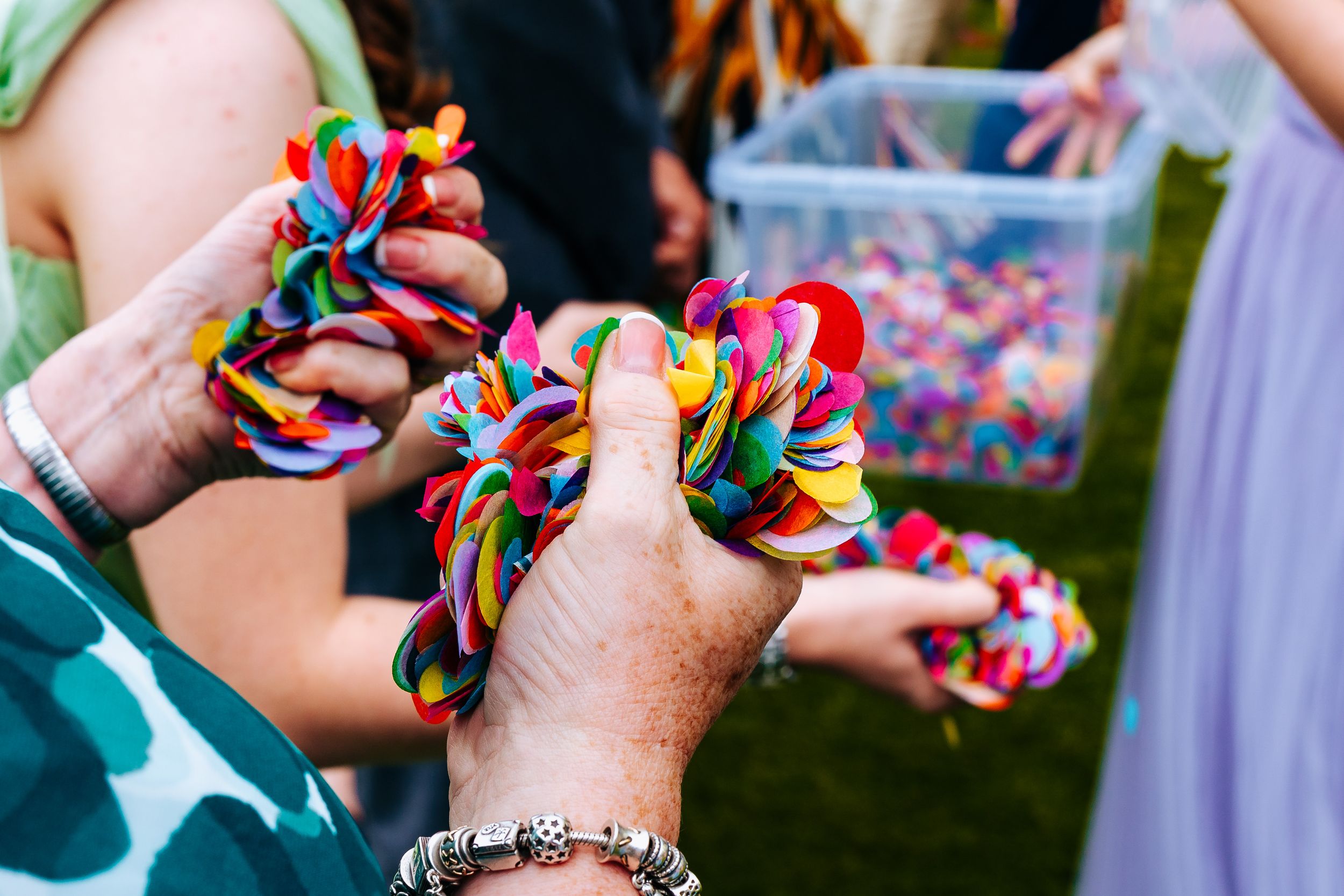 Really colourful confetti with hands grabbing a handful ready to throw