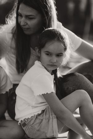 Intimate black and white portrait showing tender moment outdoors.