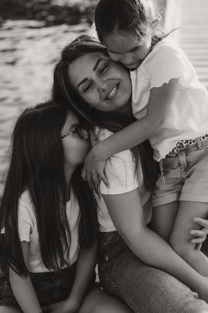 Black and white portrait capturing spontaneous embrace and laughter.