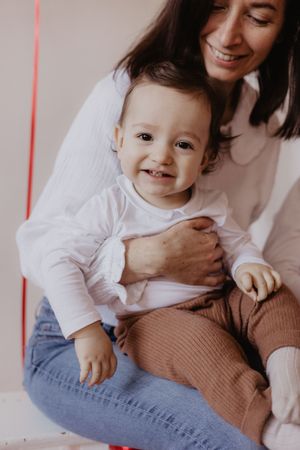 Candid shots of parent and toddler playing together in cozy home setting.