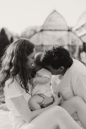 Intimate black and white portrait of couple sharing tender moments outdoors.