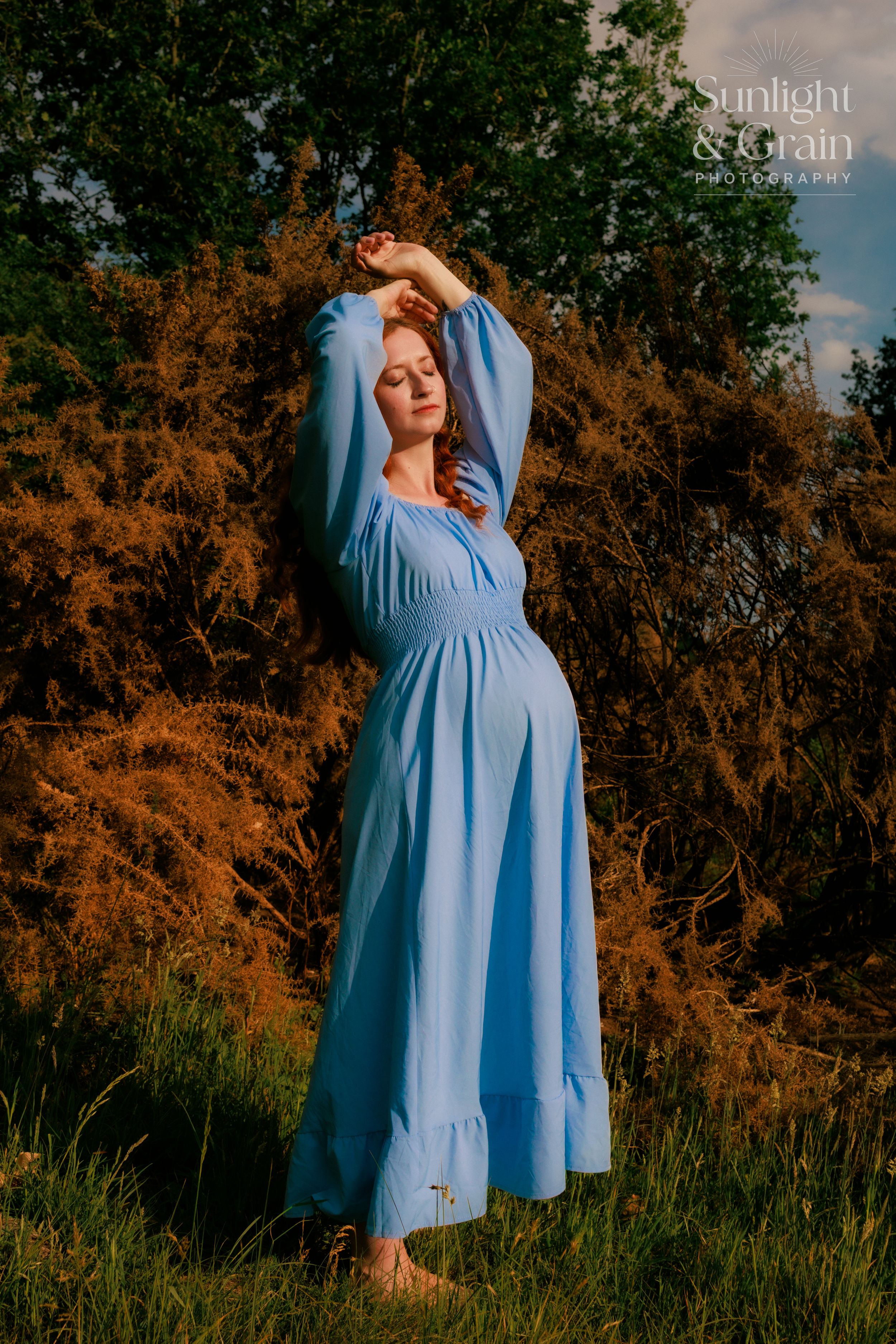 Outdoor maternity soulful, natural light, colourful, blue dress, stretching to the sunlight, Thetford, female empowerment session