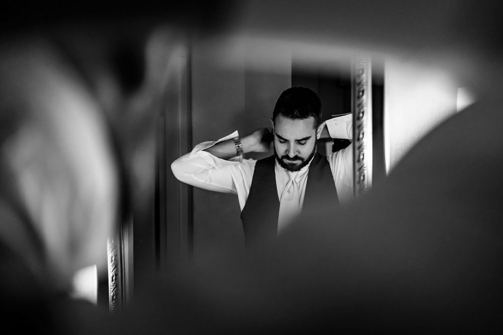 Dramatic black and white wedding photography with creative framing and shadows.