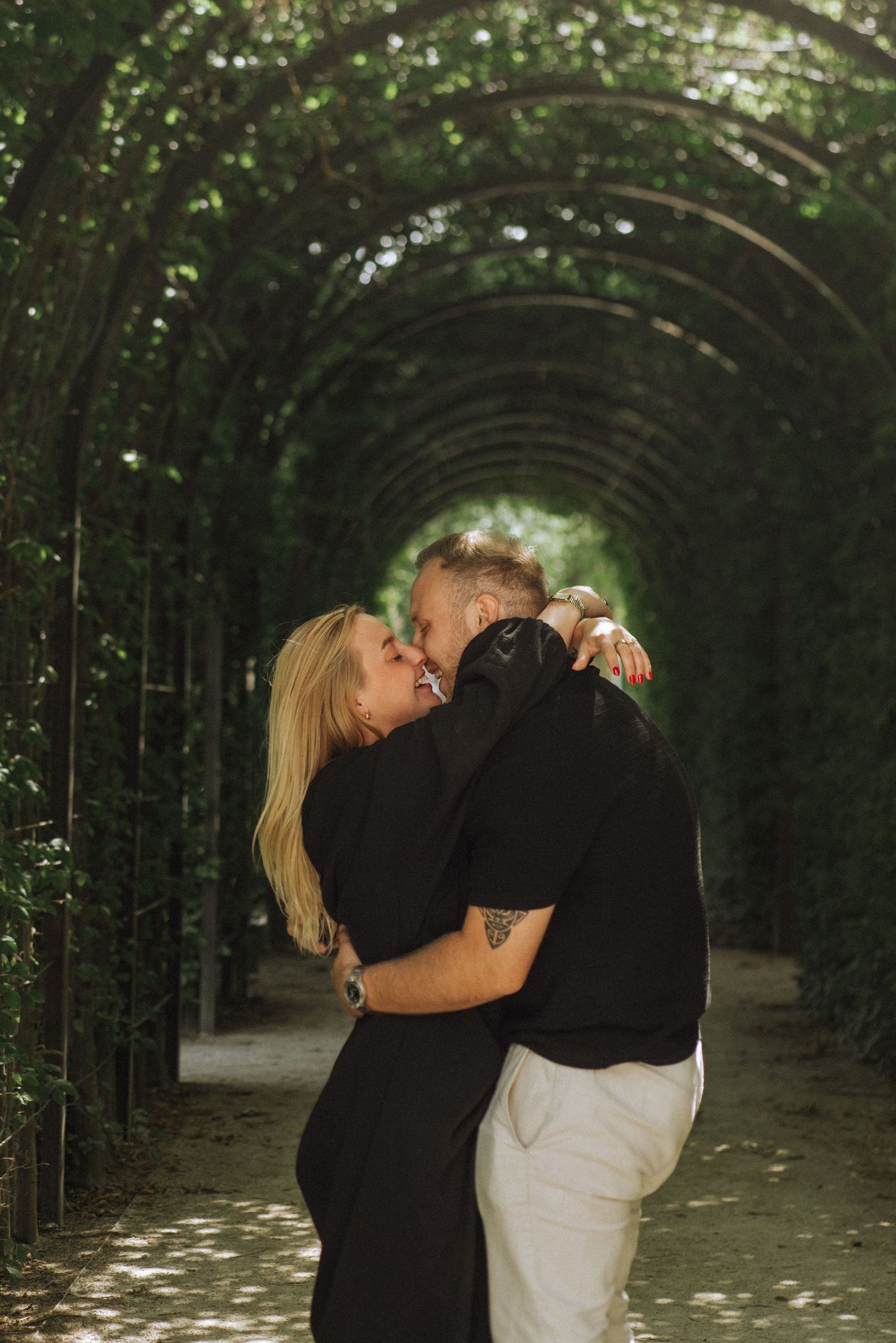 Engagement moments in the lush Rijksmuseum Gardens with a joyful, newly engaged couple.