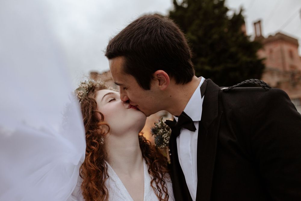 A romantic wedding portrait in silhouette captures an intimate kiss.