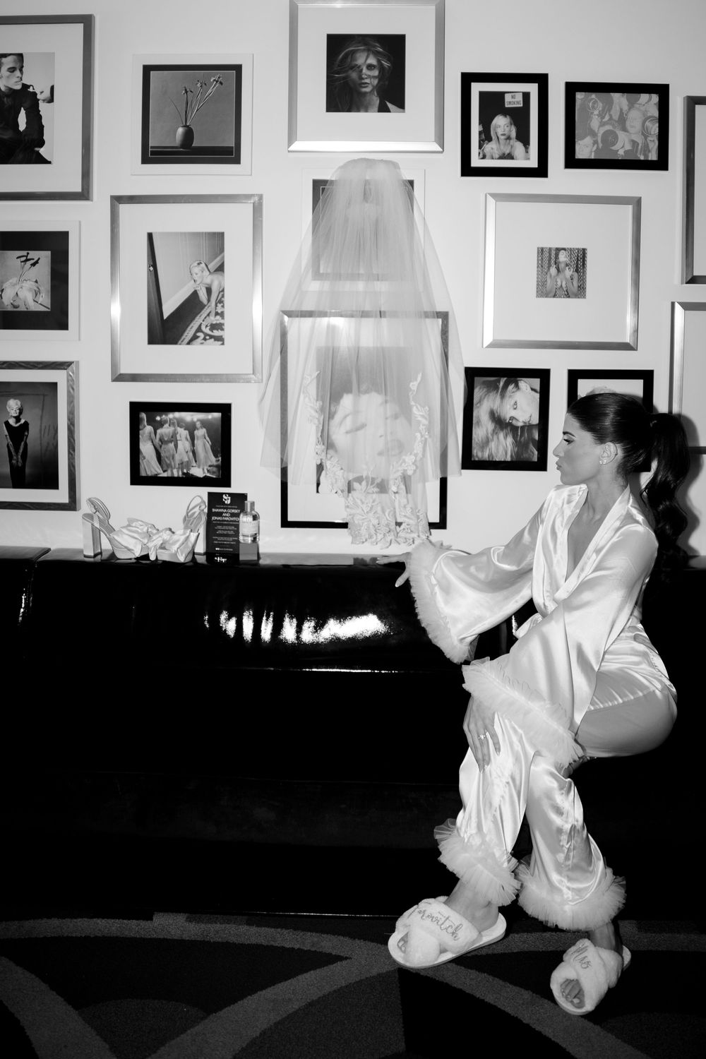 A black and white photo series showing ethereal floating white fabrics with framed artwork visible on dark walls.