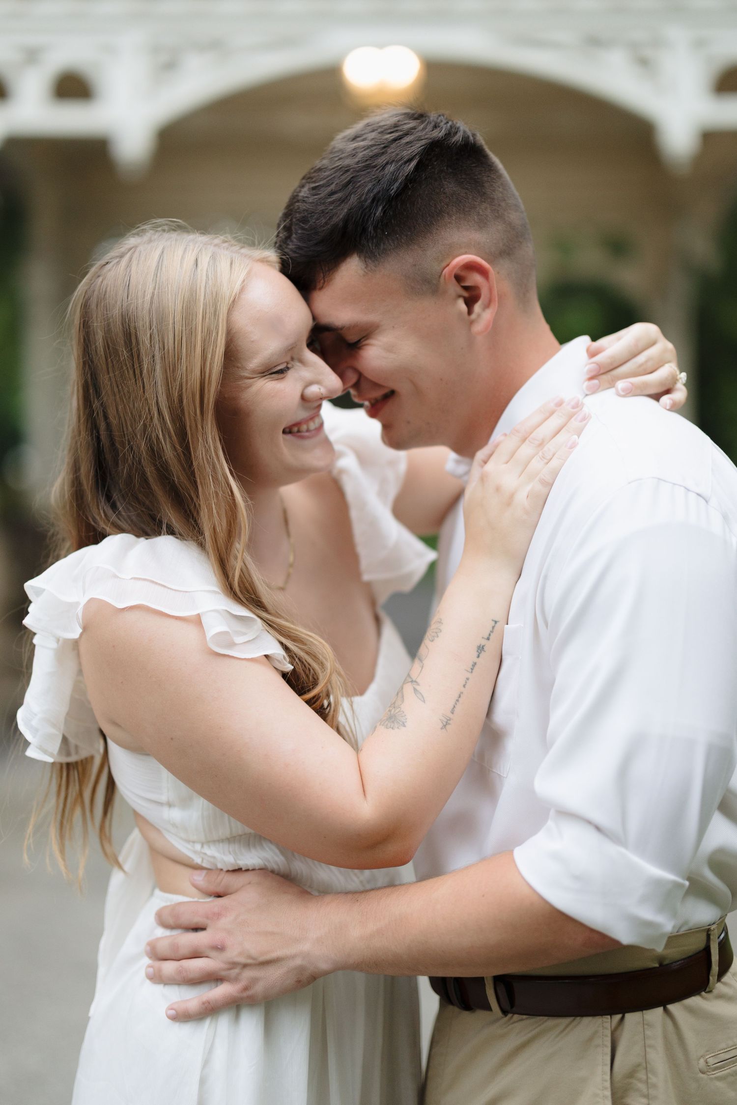Close-up shots of a couple embracing and sharing intimate moments in white and casual attire.