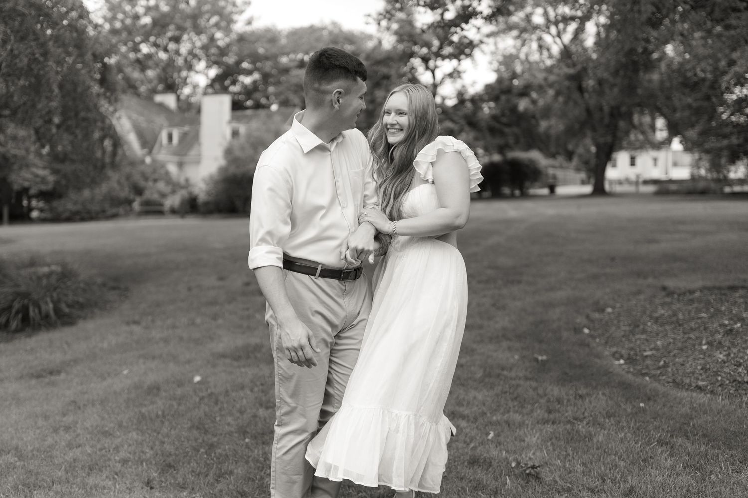 A black and white photo collage shows a romantic couple in outdoor settings at what appears to be an engagement session.