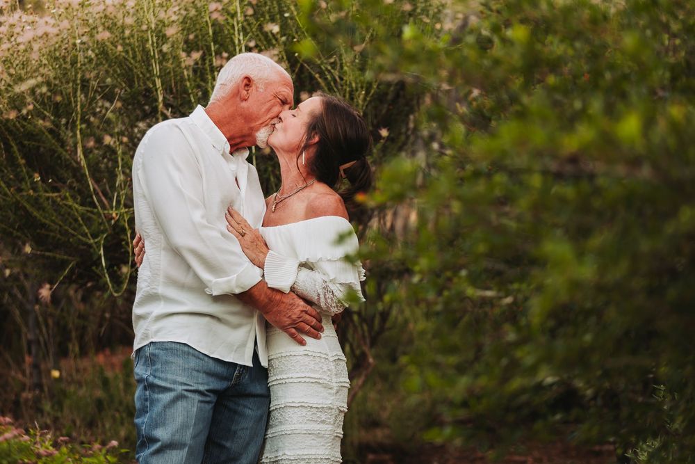 A romantic dance sequence captured in a garden setting with natural golden hour lighting.