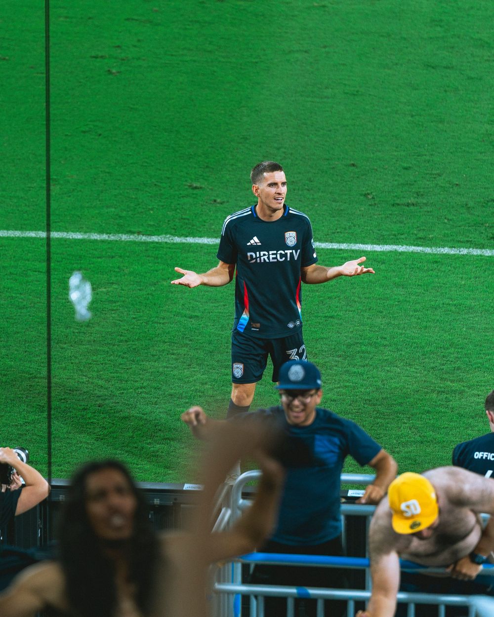 A player celebrates in front of a cheering crowd