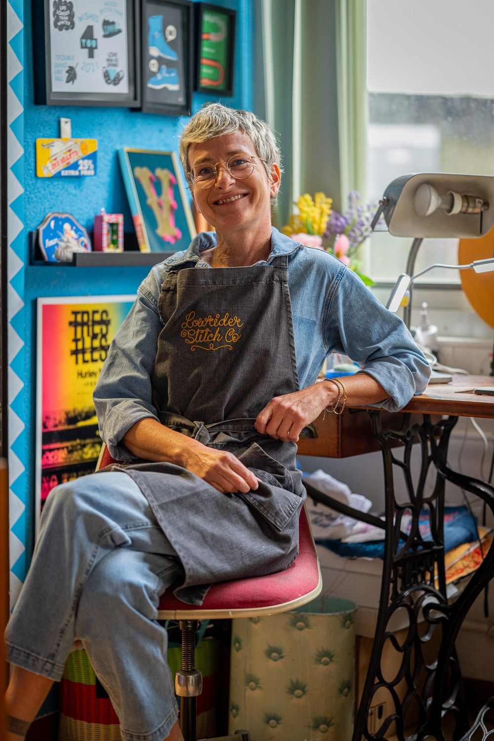A series of four connected photos showing someone sitting comfortably in a wheelchair at a desk in a classroom setting.