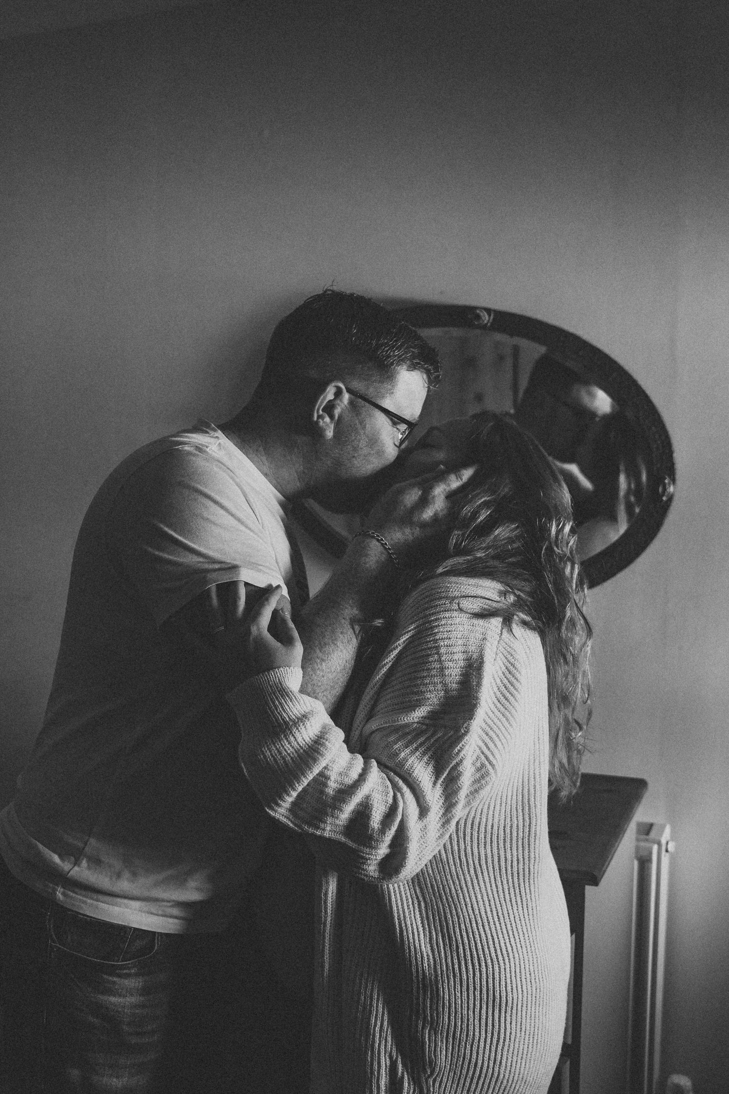 A romantic black and white photo series showing an intimate embrace.