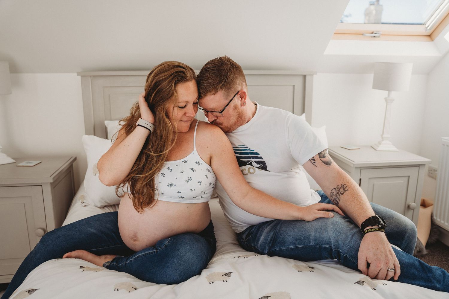 Intimate lifestyle photography session in a bright modern bedroom.