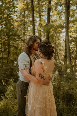Kendall and Lane prepare for their elopement ceremony in Red River Gorge, Kentucky, Lane kissing Kendall's forehead.