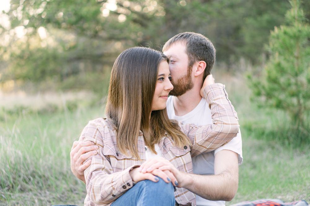 Peaceful couple dancing at golden hour in a rural Minnesota field during a dreamy, light-filled engagement shoot