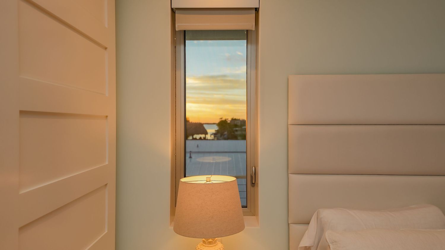 Interior view of a modern coastal vacation home showcasing elegant white doors and soft lighting.