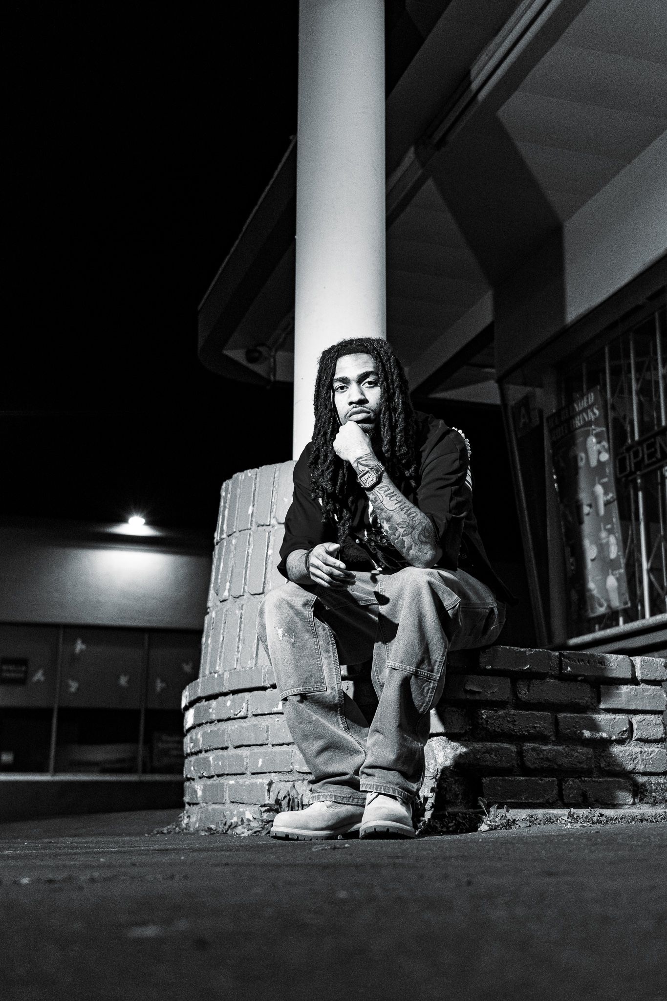 A black and white photo sequence shows someone sitting on stone steps in low light, creating a moody atmosphere.