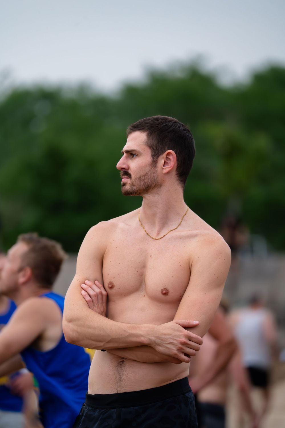 An athlete watches play while waiting on the sideline