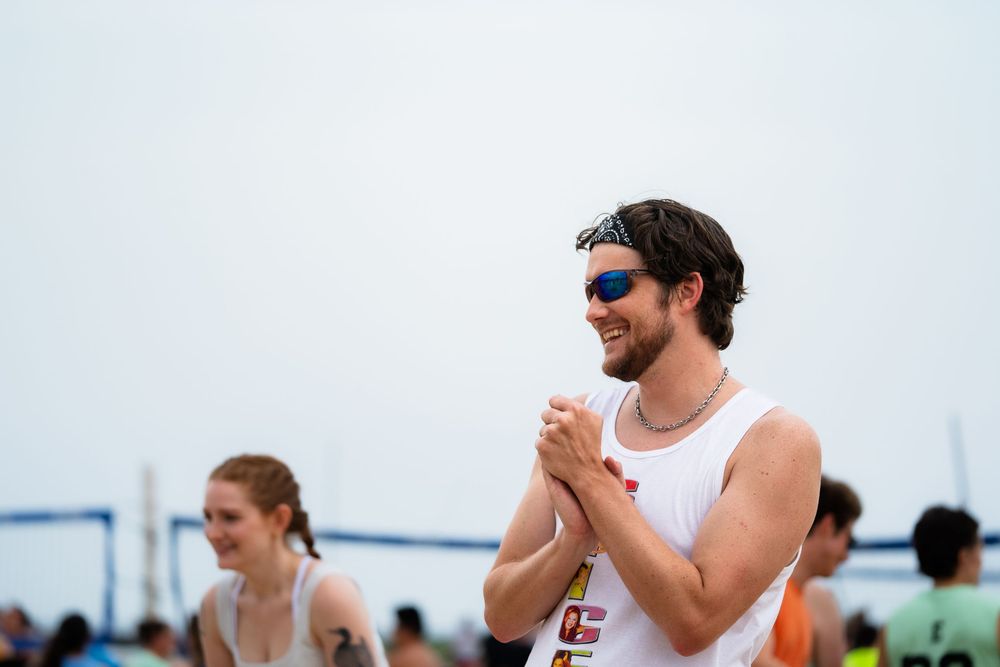 An athlete celebrates a point by clapping and smiling
