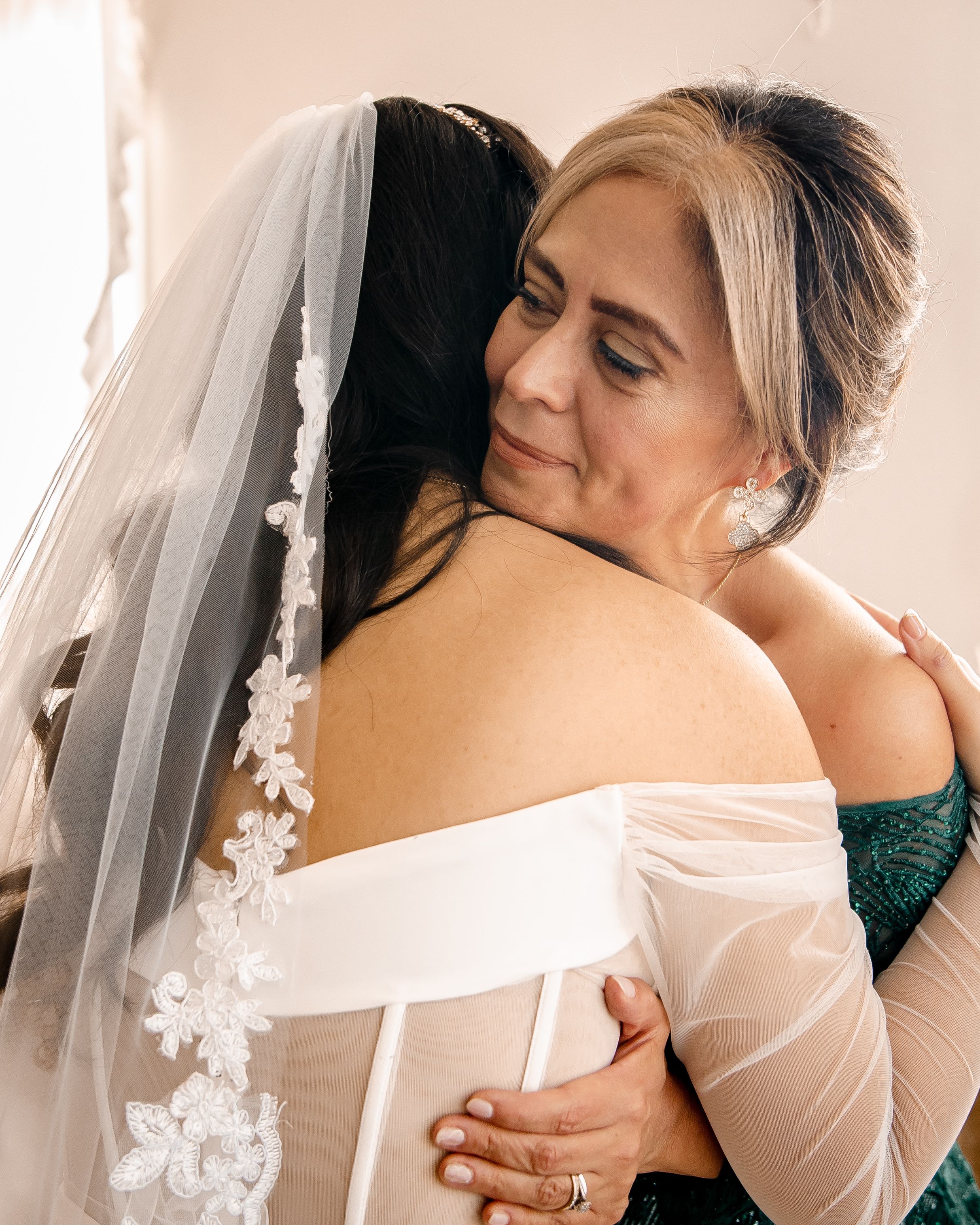 Emotional embrace captured in a series of wedding photos showing tender moments between loved ones.