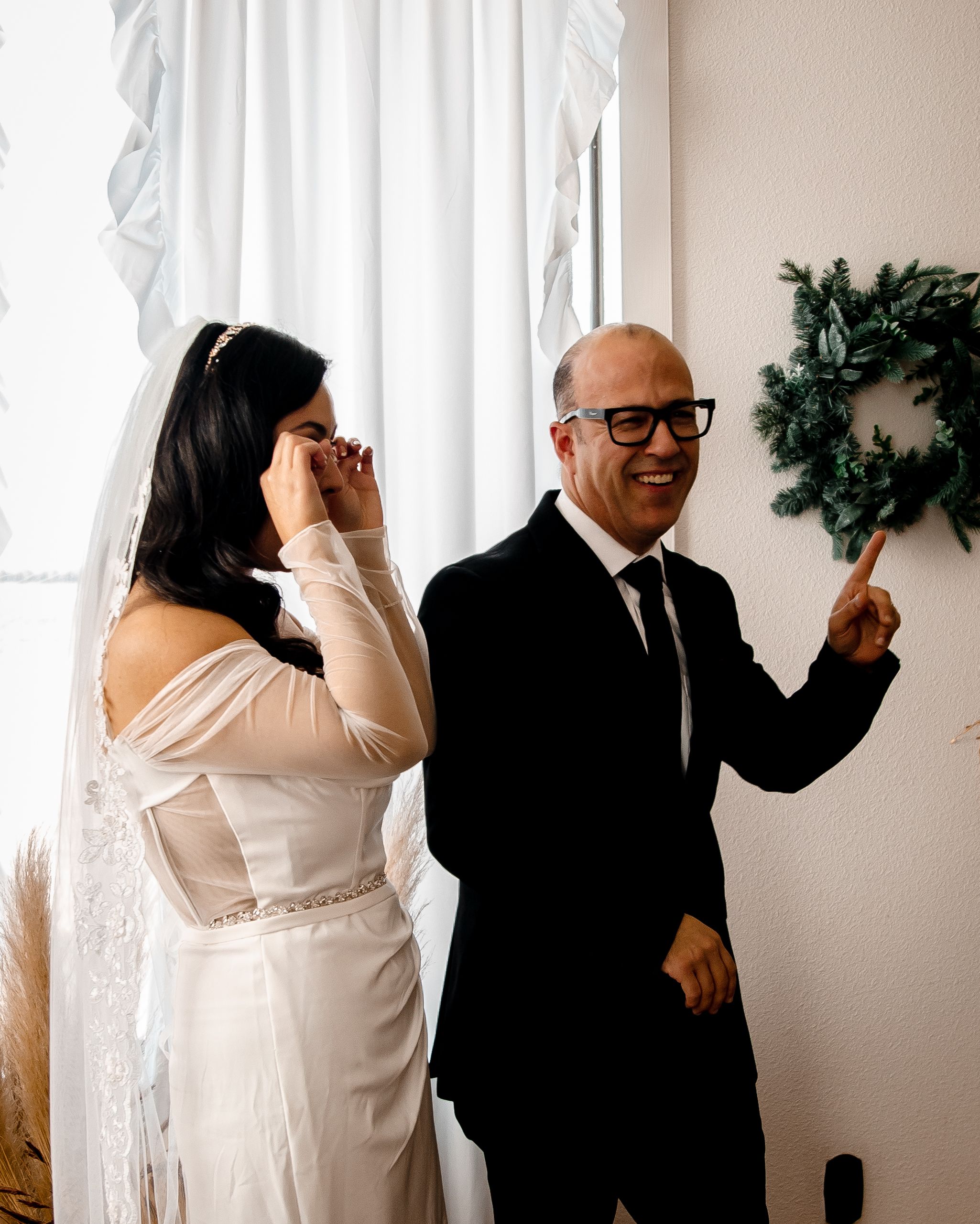 A series of candid black and white wedding photos showing joyful moments between a couple in formal attire.
