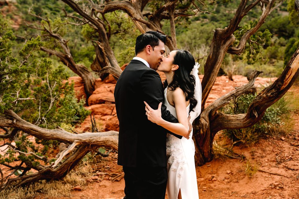 A romantic moment shared between a couple during their Sedona desert wedding photoshoot.