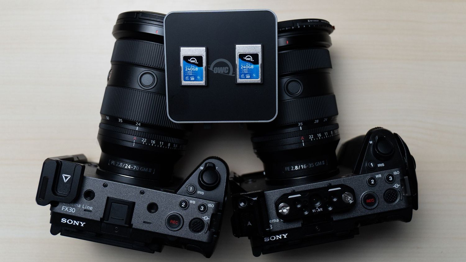 Black digital camera with two blue indicator lights mounted on top.