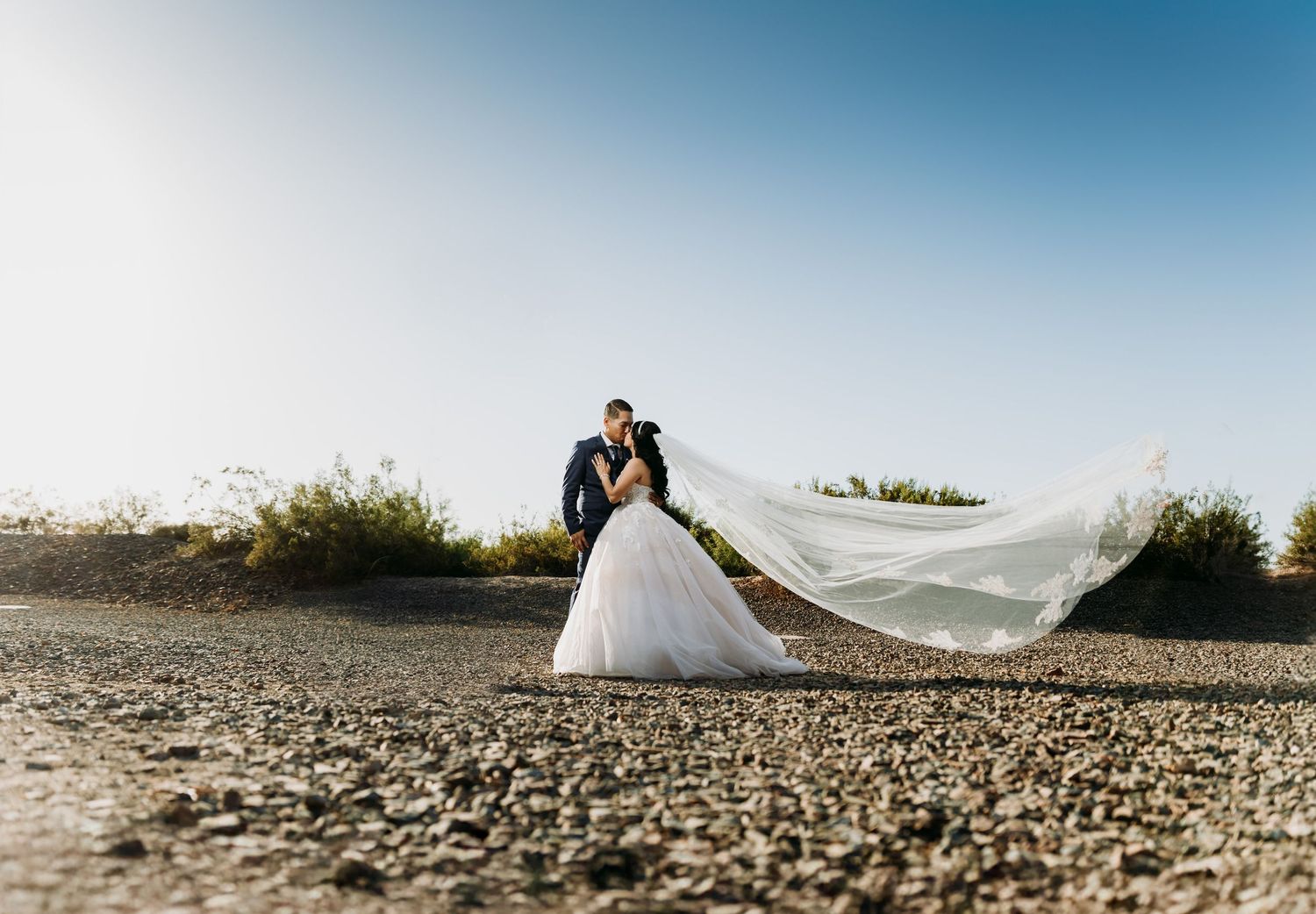Wedding Picture of Groom and Bride with her veil flowing in San Luis, Arizona and Yuma, Arizona