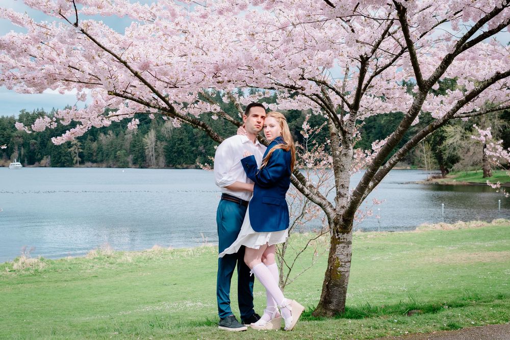 Seattle couples portrait under blooming cherry blossom trees at a lakeside park during spring photography session