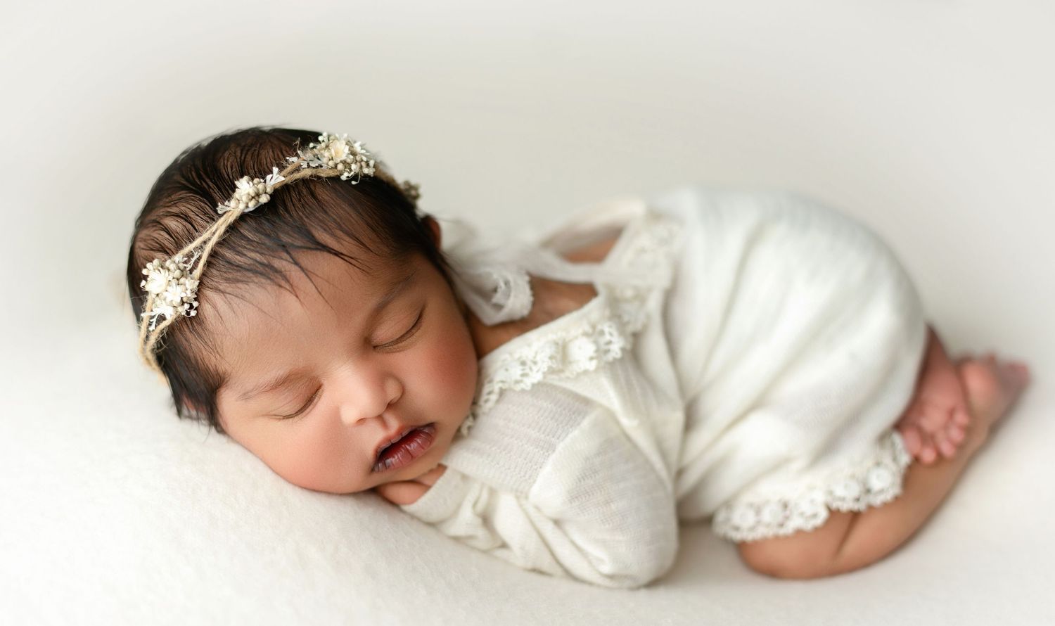 An ethnic newborn baby in a cream outfit. Greenville SC newborn photographer, Easley, SC newborn photographer, Upstate newborn photographer
