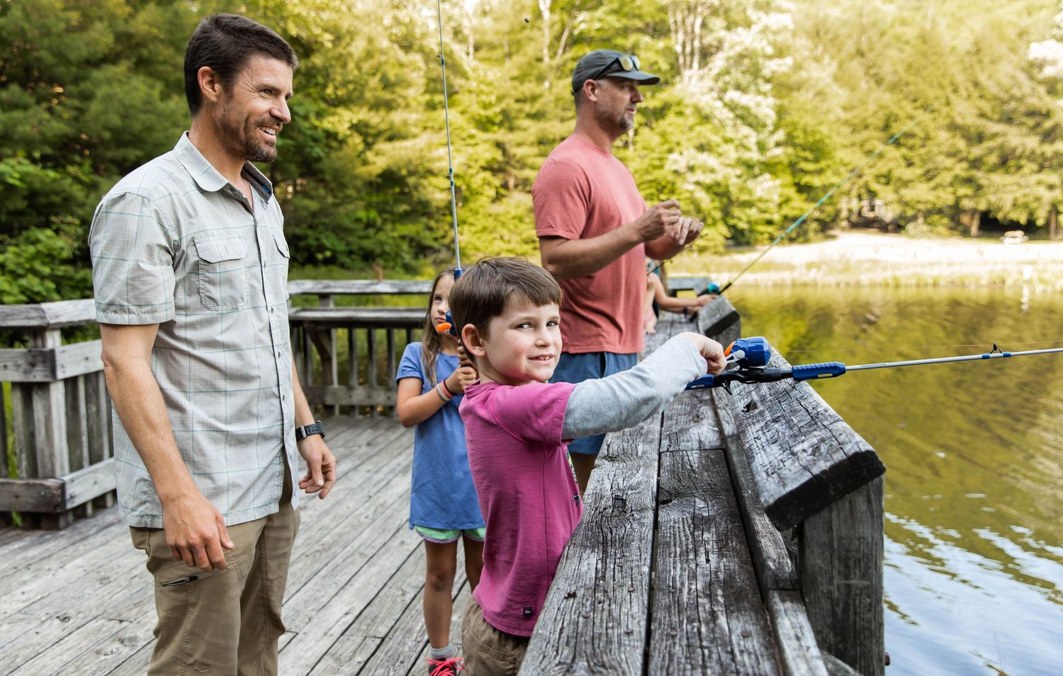Photo of a family and friends fishing at the lake with Zebco reels