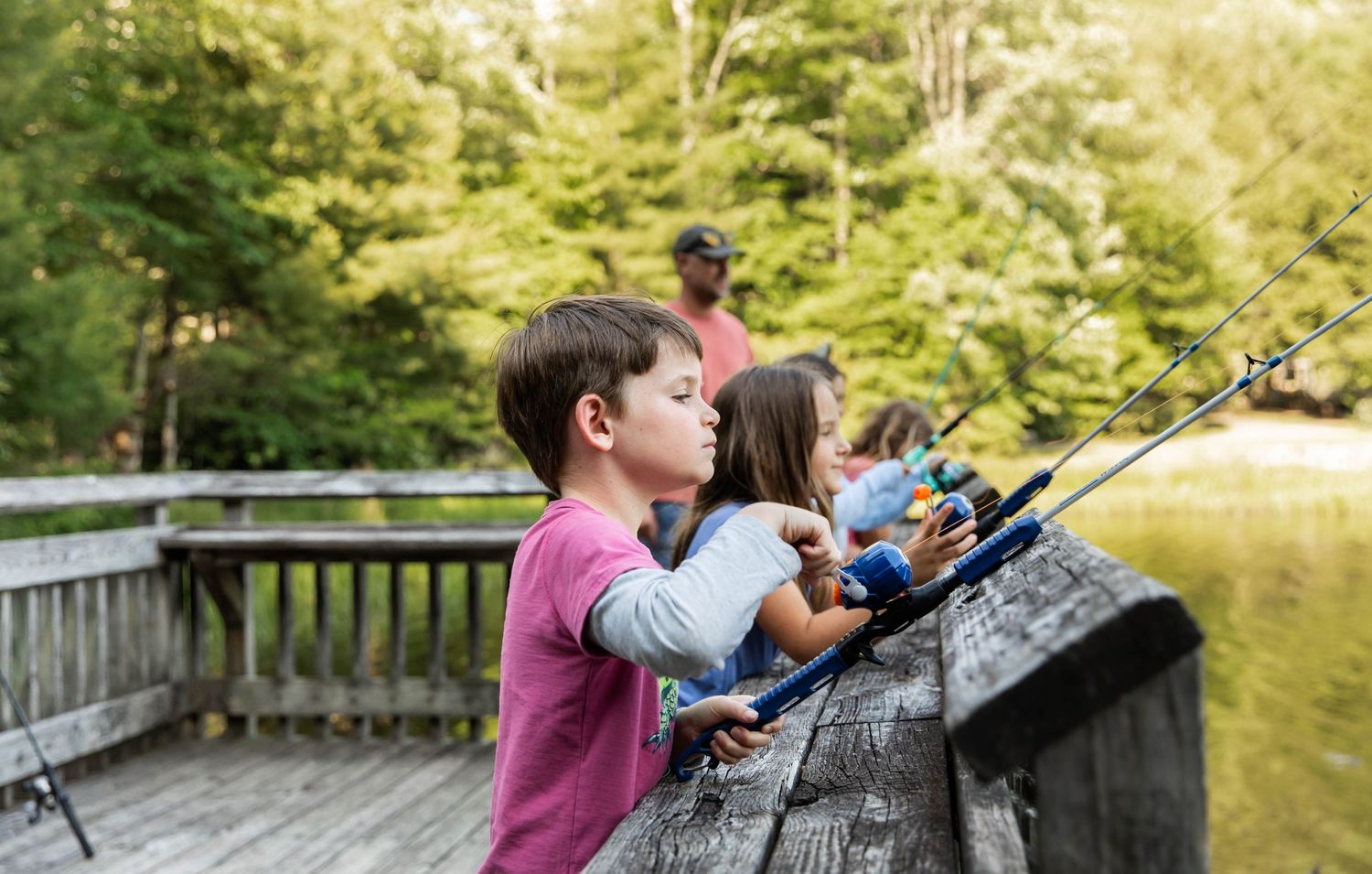 Photo of a family and friends fishing at the lake with Zebco reels