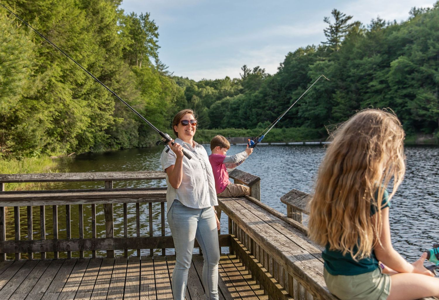 Photo of a family fishing at the lake with Zebco reels